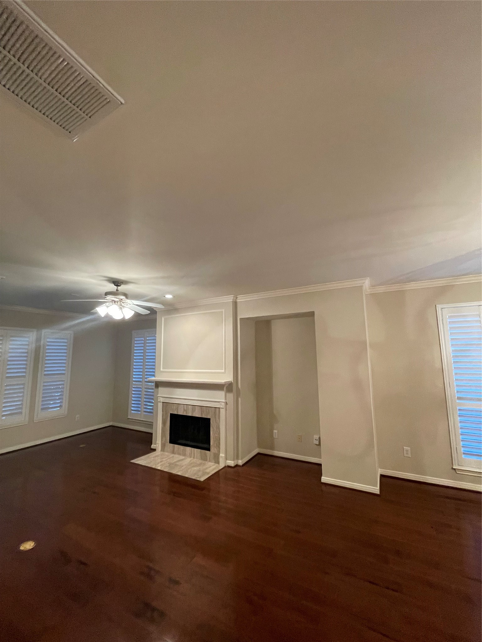 1040 La Rue Street Houston, TX 77019 - Photo 18 of 29 an empty room with wooden floor fireplace and windows