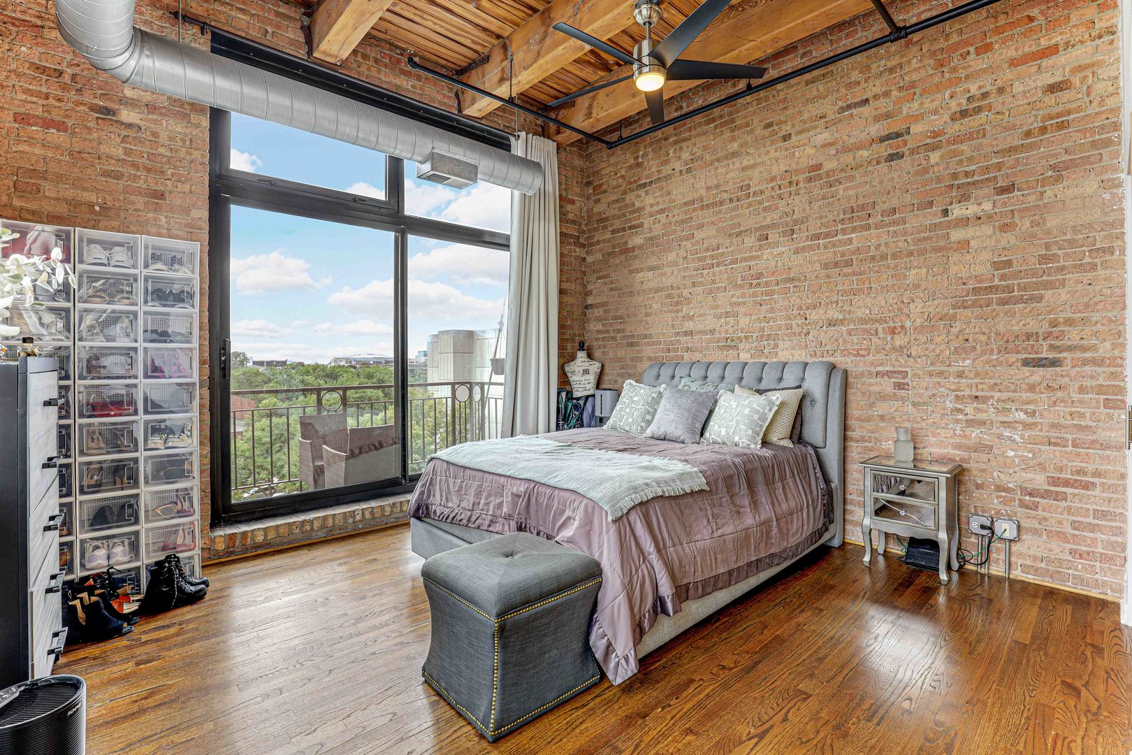 1250 West Van Buren Street, Unit 515 Chicago, IL 60607 - Photo 12 of 17 a bed sitting in a spacious bedroom next to a window