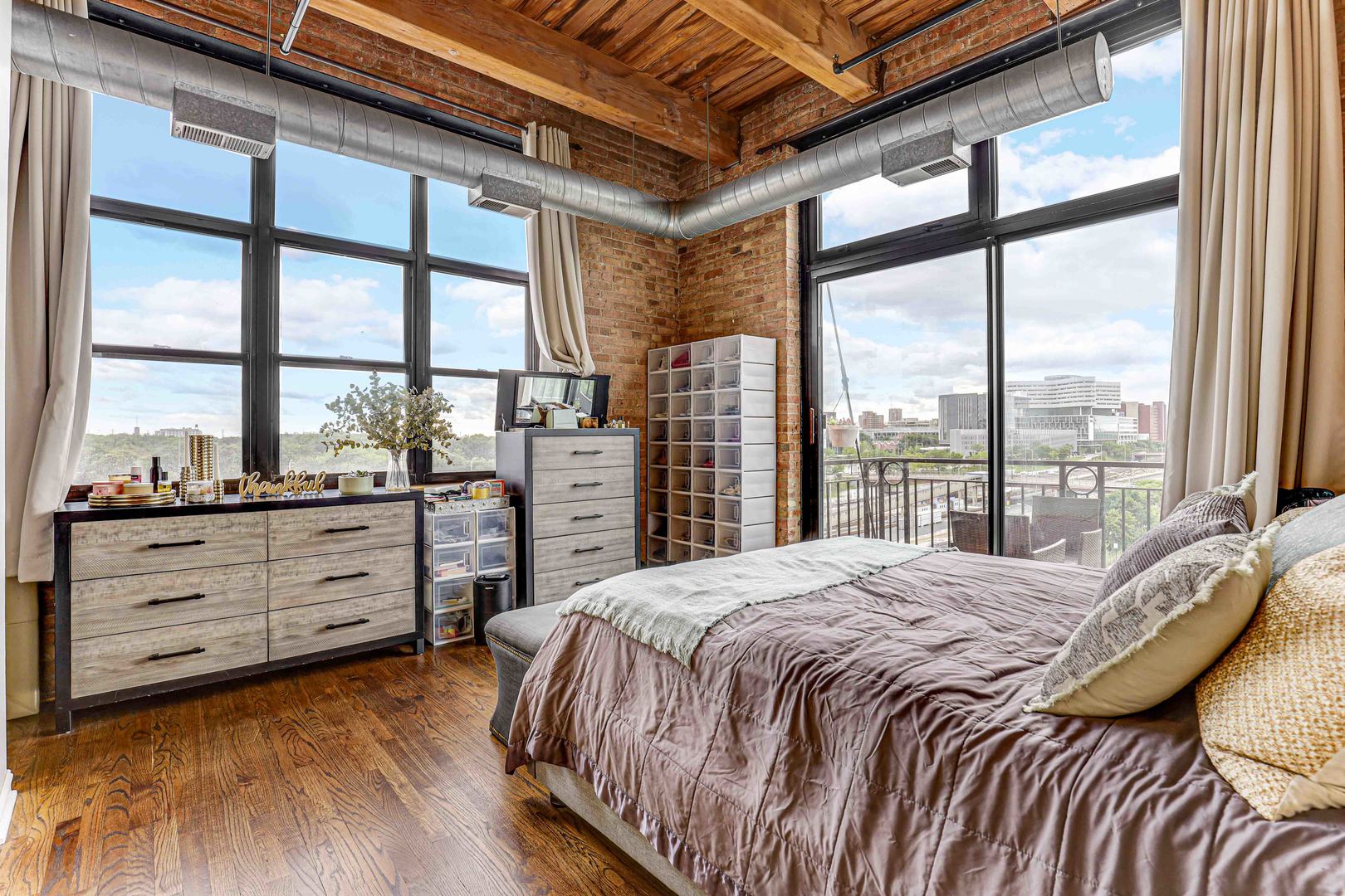 1250 West Van Buren Street, Unit 515 Chicago, IL 60607 - Photo 13 of 17 a bedroom with a bed and large windows