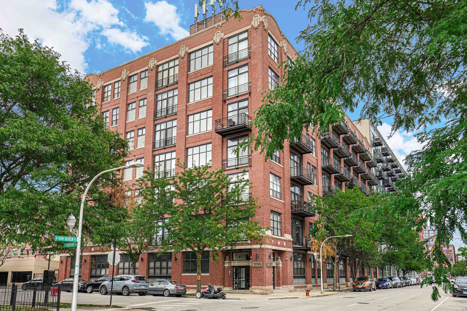 1250 West Van Buren Street, Unit 515 Chicago, IL 60607 - Photo 17 of 17 a view of a tall building next to a road