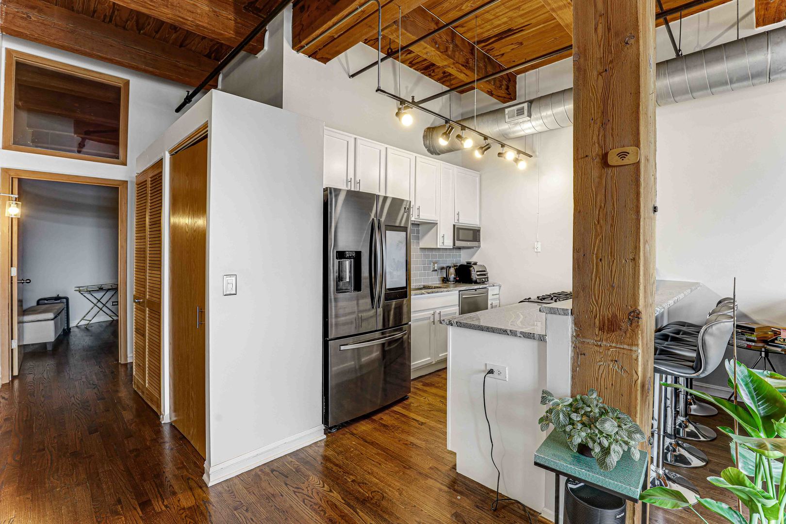 1250 West Van Buren Street, Unit 515 Chicago, IL 60607 - Photo 2 of 17 a kitchen with stainless steel appliances a refrigerator and a stove
