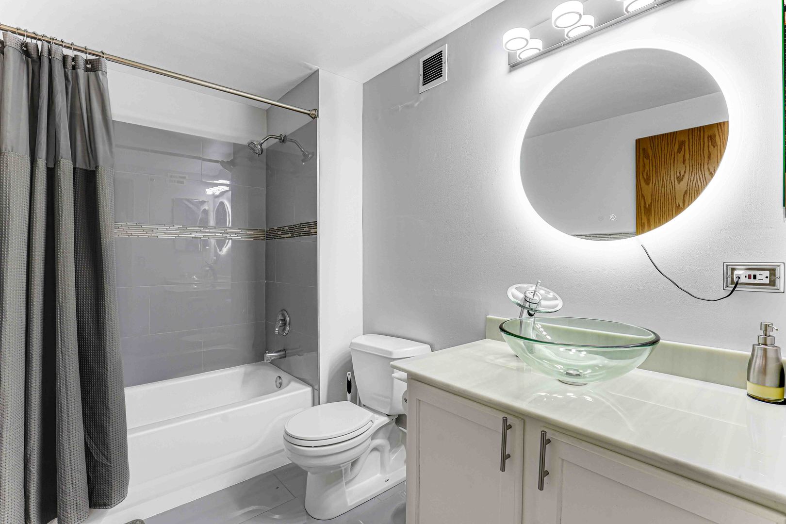 1250 West Van Buren Street, Unit 515 Chicago, IL 60607 - Photo 10 of 17 a bathroom with a granite countertop sink toilet and shower