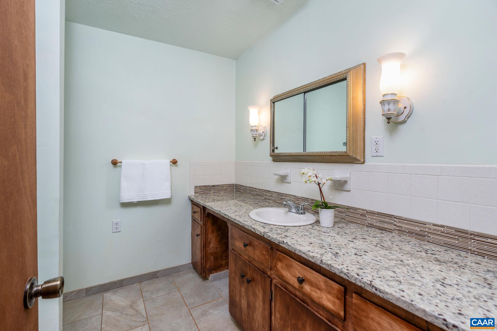 77 Sunset Drive Arrington, VA 22922 - Photo 19 of 35 a bathroom with a granite countertop sink and a mirror