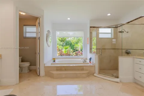 a bathroom with a bathtub and a shower