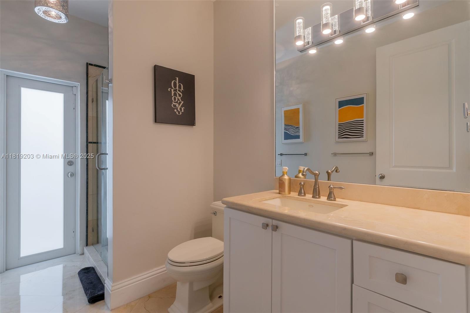 9532 Southwest 124th Terrace Miami, FL 33176 - Photo 18 of 30 a bathroom with a sink a toilet and mirror