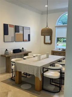 a kitchen with a table chairs a sink dishwasher and a stove