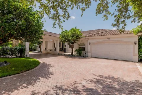 a view of a house with a yard and garage