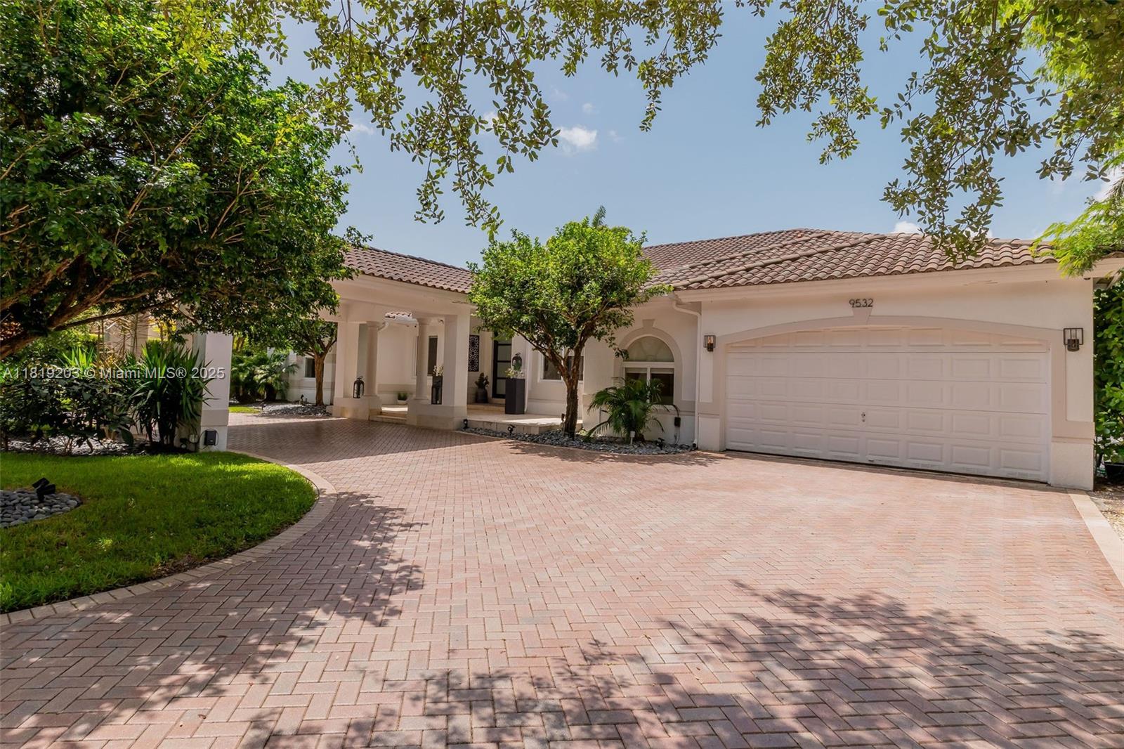 9532 Southwest 124th Terrace Miami, FL 33176 - Photo 3 of 30 a view of a house with a yard and garage