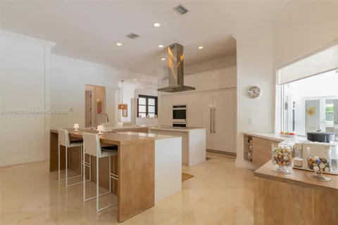 a large kitchen with a table and chairs