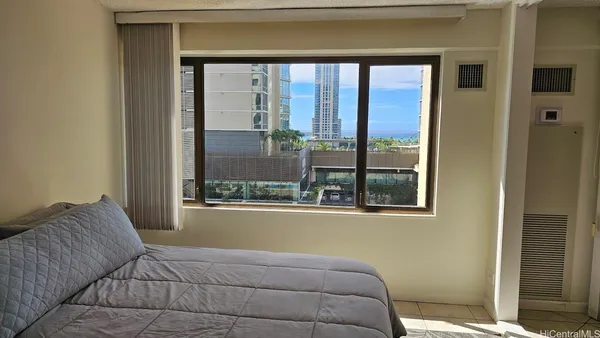 a bedroom with a bed and a window