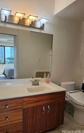 a bathroom with a sink a toilet and mirror