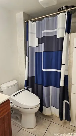 a white toilet sitting next to a bathroom sink