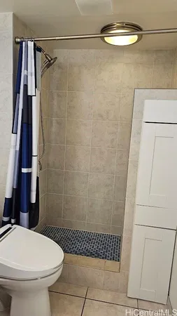 a bathroom with a toilet and a shower