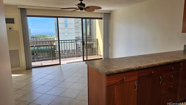 a hallway with a granite countertop sink and cabinets