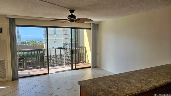 a view of a livingroom with a ceiling fan and window