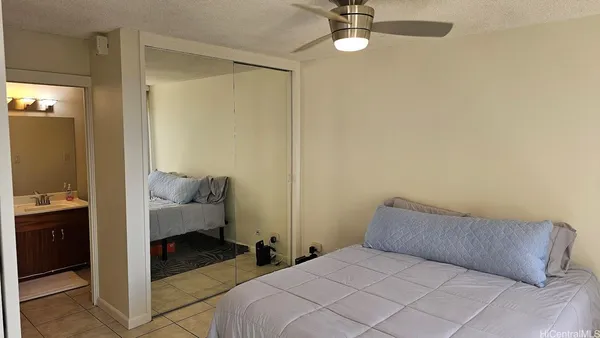 a bedroom with a bed and ceiling fan