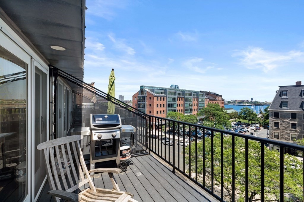 220 Commercial Street, Unit 5A Boston, MA 02109 - Photo 11 of 40 a view of a balcony with wooden chairs
