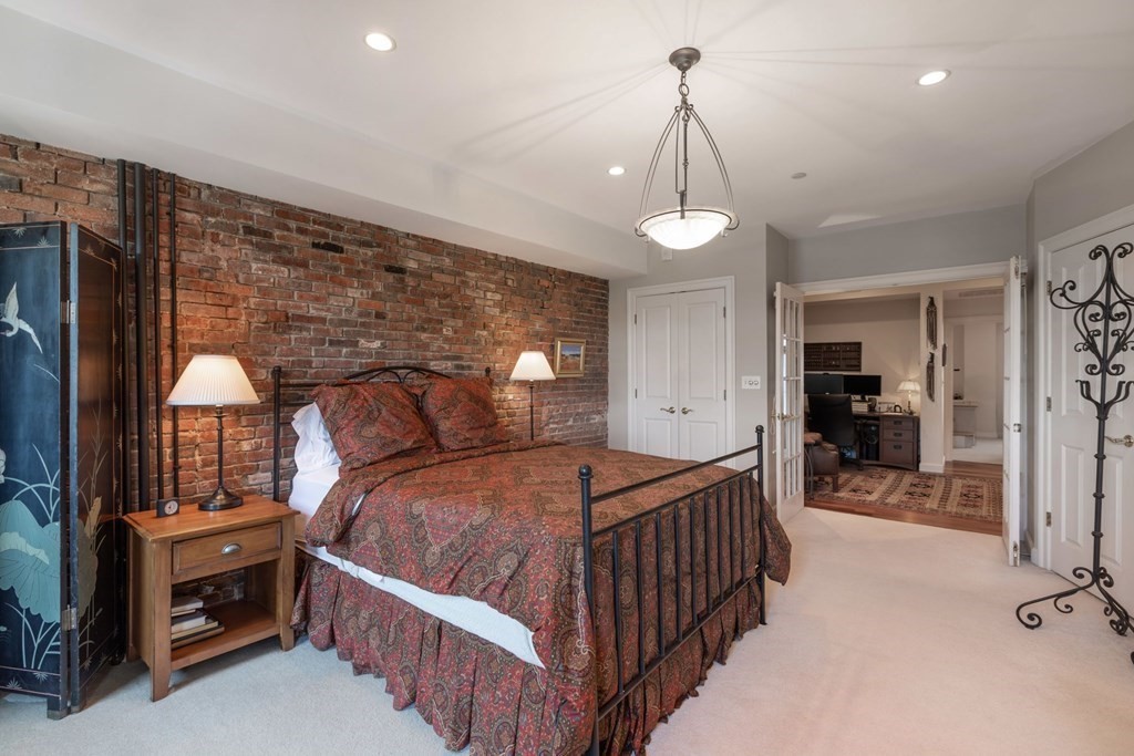 220 Commercial Street, Unit 5A Boston, MA 02109 - Photo 16 of 40 a bedroom with a bed and a chandelier