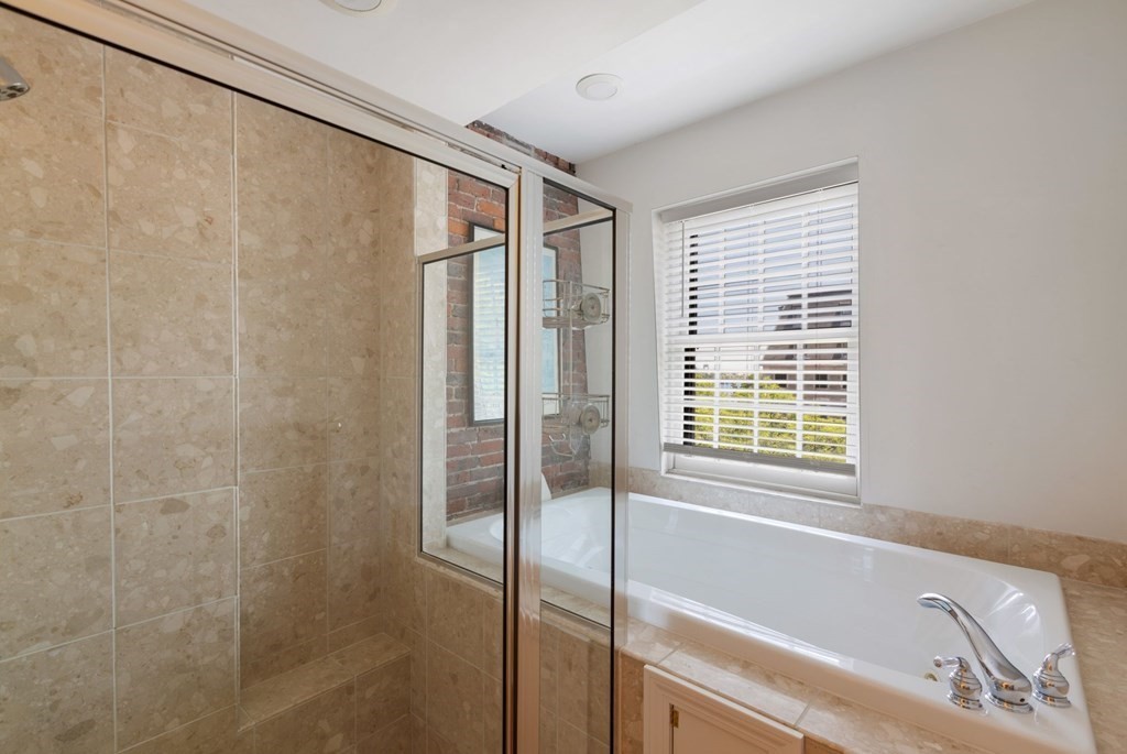 220 Commercial Street, Unit 5A Boston, MA 02109 - Photo 20 of 40 a bathroom with a bathtub and a shower