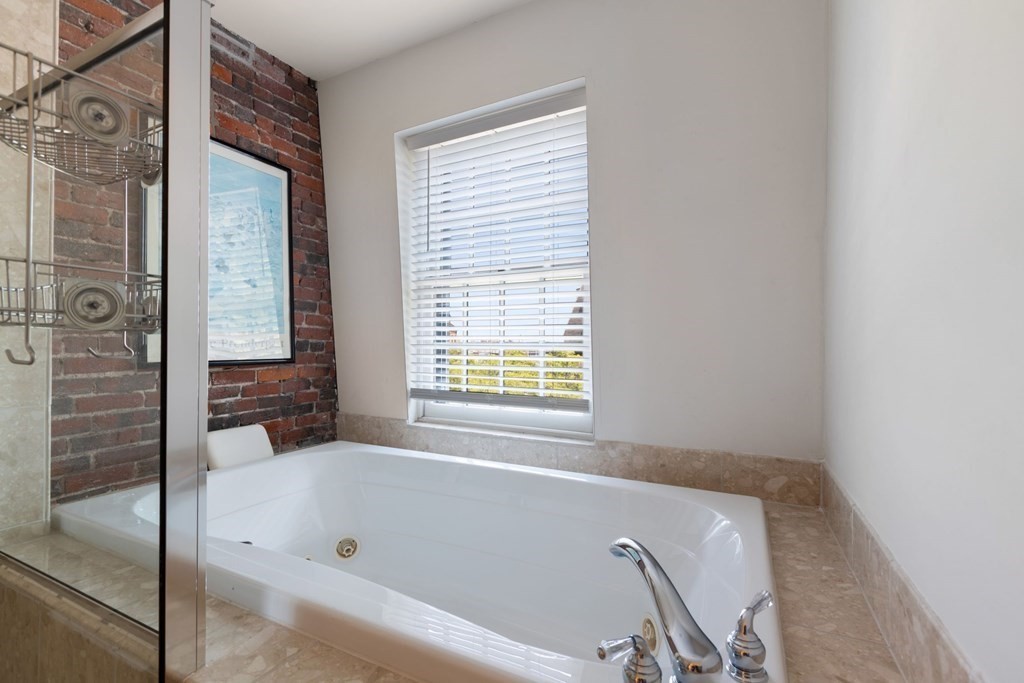 220 Commercial Street, Unit 5A Boston, MA 02109 - Photo 21 of 40 a bathroom with a bathtub and a shower