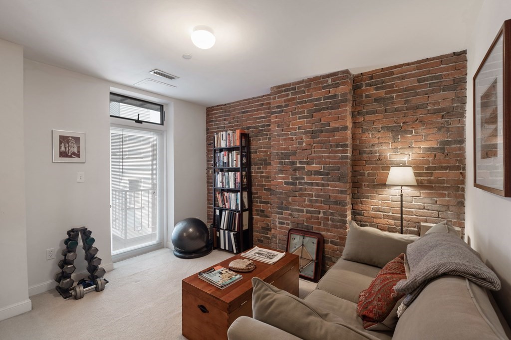 220 Commercial Street, Unit 5A Boston, MA 02109 - Photo 22 of 40 a living room with furniture a window and gym equipment