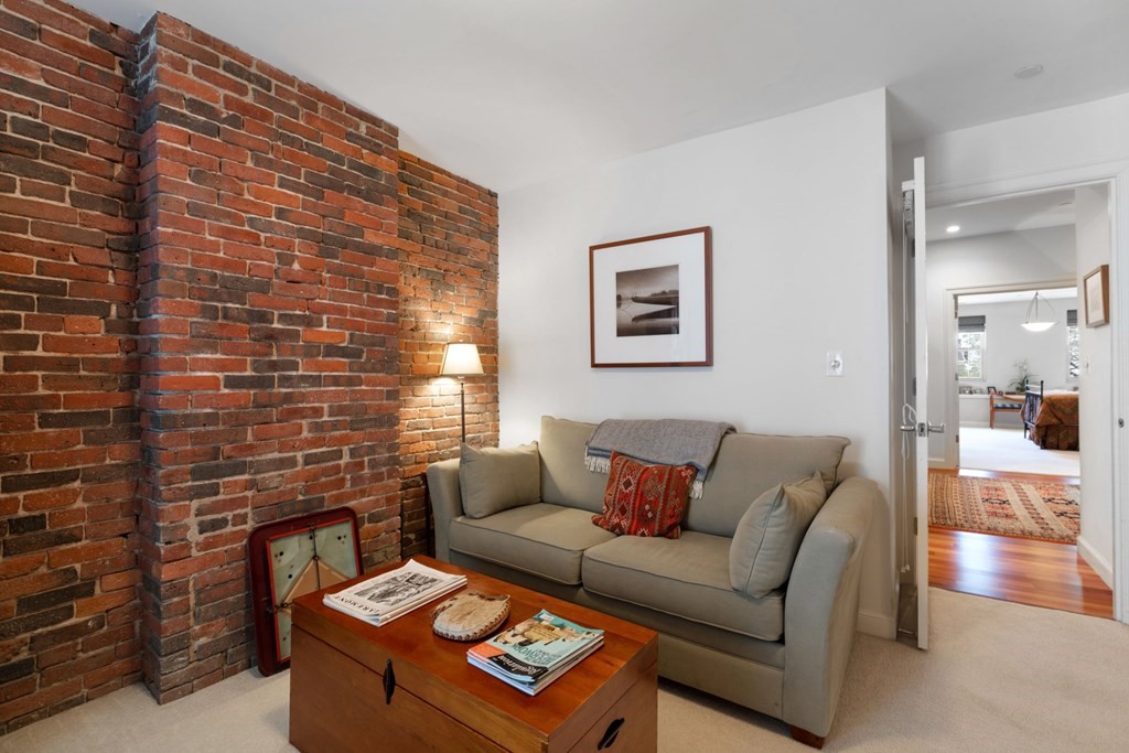 220 Commercial Street, Unit 5A Boston, MA 02109 - Photo 23 of 40 a living room with furniture and a fireplace