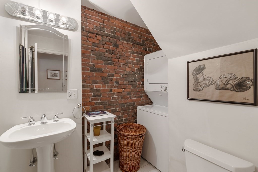 220 Commercial Street, Unit 5A Boston, MA 02109 - Photo 27 of 40 a bathroom with a sink and a mirror