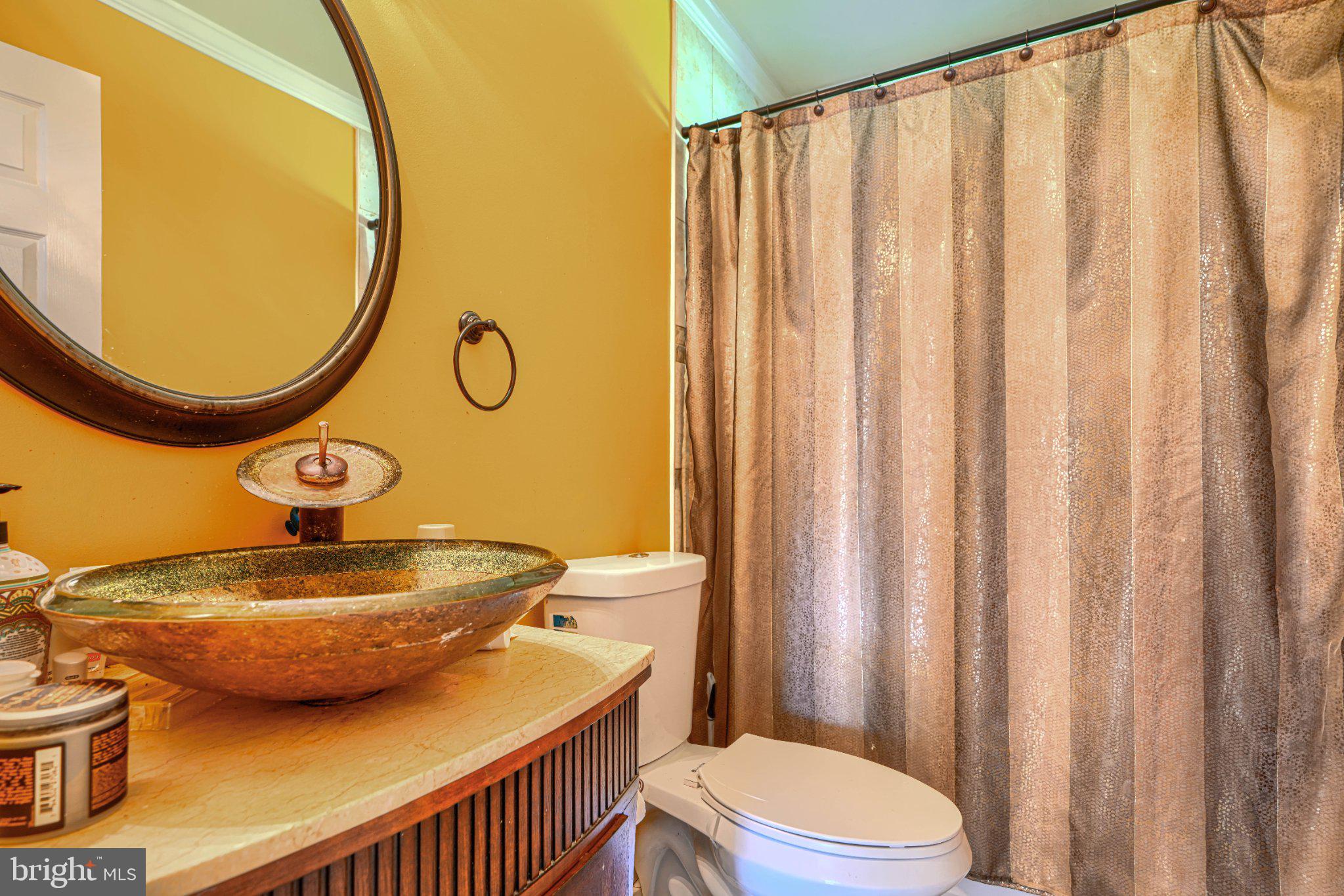 3708 Cassen Road Randallstown, MD 21133 - Photo 19 of 38 a bathroom with a sink a toilet and a mirror