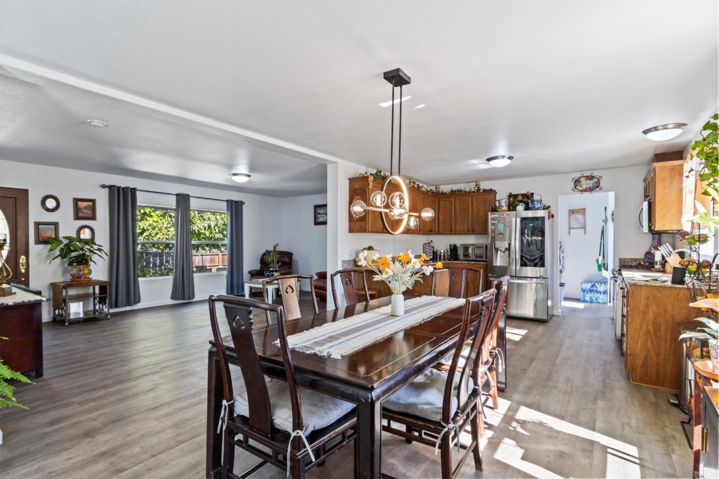 37200 Nason Road, Unit 18 Carmel Valley, CA 93924 - Photo 12 of 71 a view of a dining room and livingroom with furniture wooden floor a chandelier