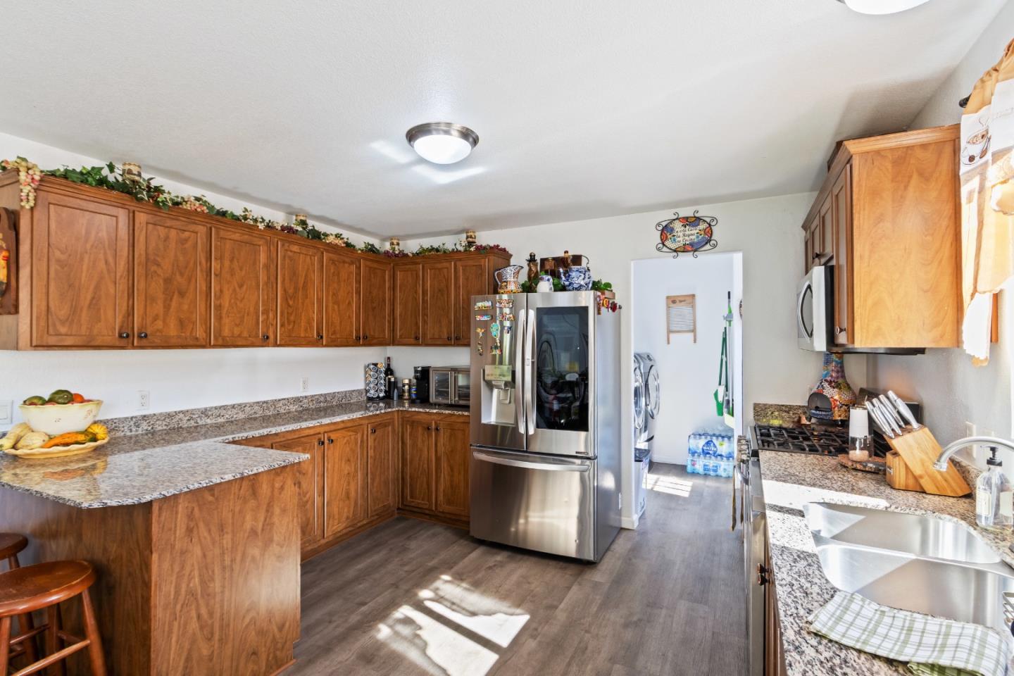 37200 Nason Road, Unit 18 Carmel Valley, CA 93924 - Photo 16 of 71 a kitchen with stainless steel appliances granite countertop a sink refrigerator and cabinets