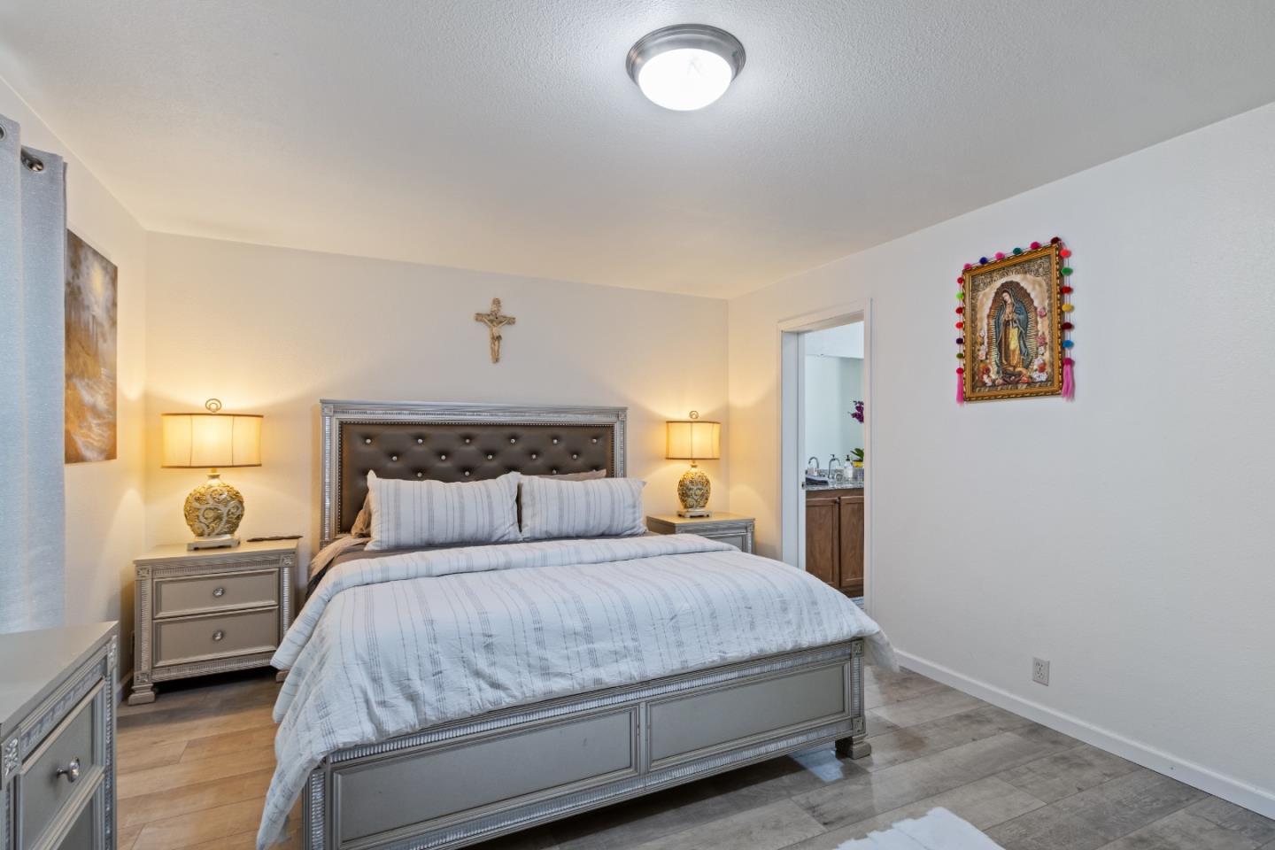 37200 Nason Road, Unit 18 Carmel Valley, CA 93924 - Photo 20 of 71 a bedroom with a bed and a painting on the wall