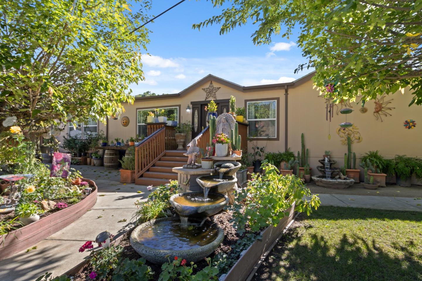 37200 Nason Road, Unit 18 Carmel Valley, CA 93924 - Photo 2 of 71 a front view of a house with a yard fountain and outdoor seating