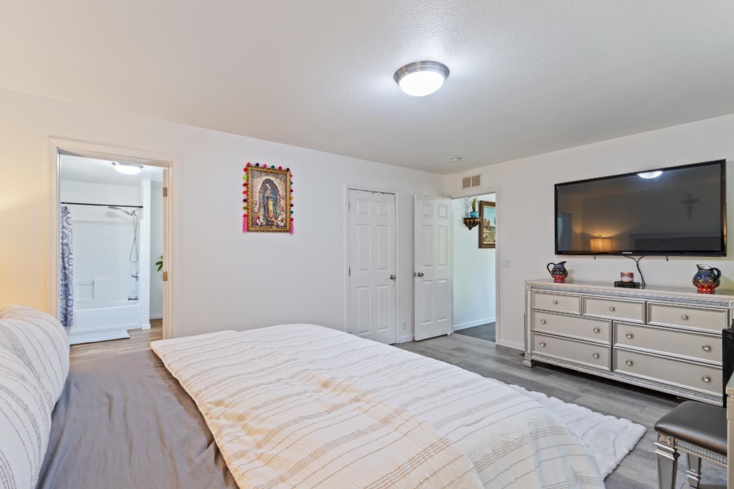 37200 Nason Road, Unit 18 Carmel Valley, CA 93924 - Photo 21 of 71 a bedroom with a bed and a flat screen tv