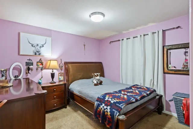 a bedroom with a bed and a dresser in it