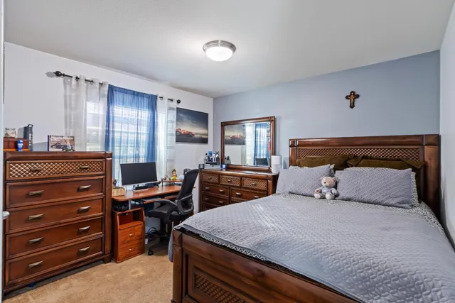 a view of a backyard with table and chairs and a fire pit