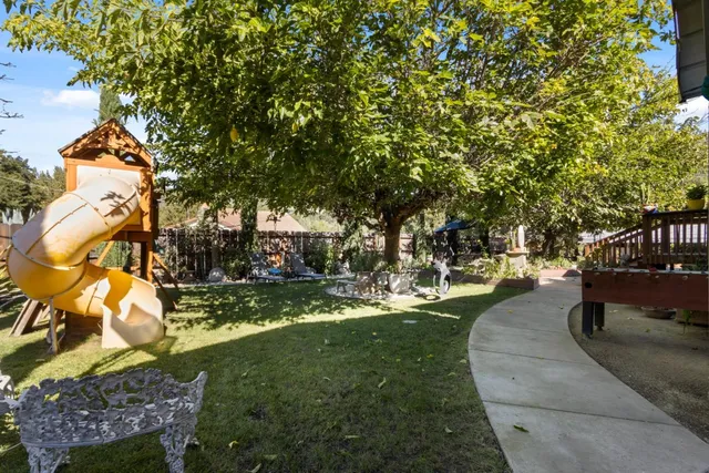 a view of backyard of house with seating space