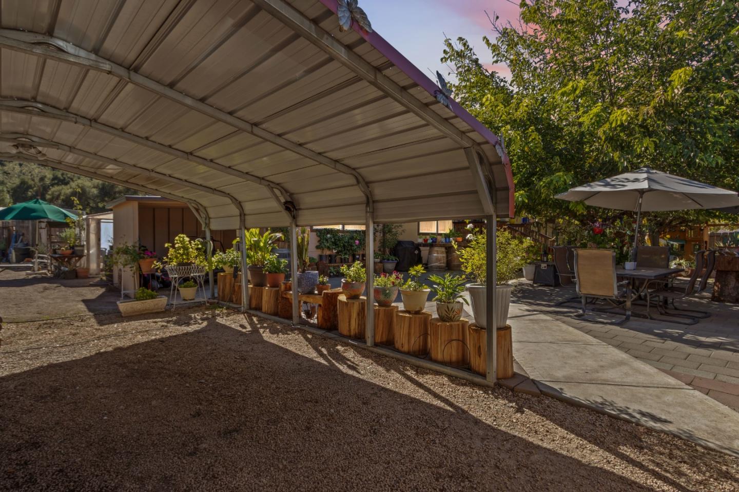 37200 Nason Road, Unit 18 Carmel Valley, CA 93924 - Photo 61 of 71 a view of a patio with table and chairs under an umbrella