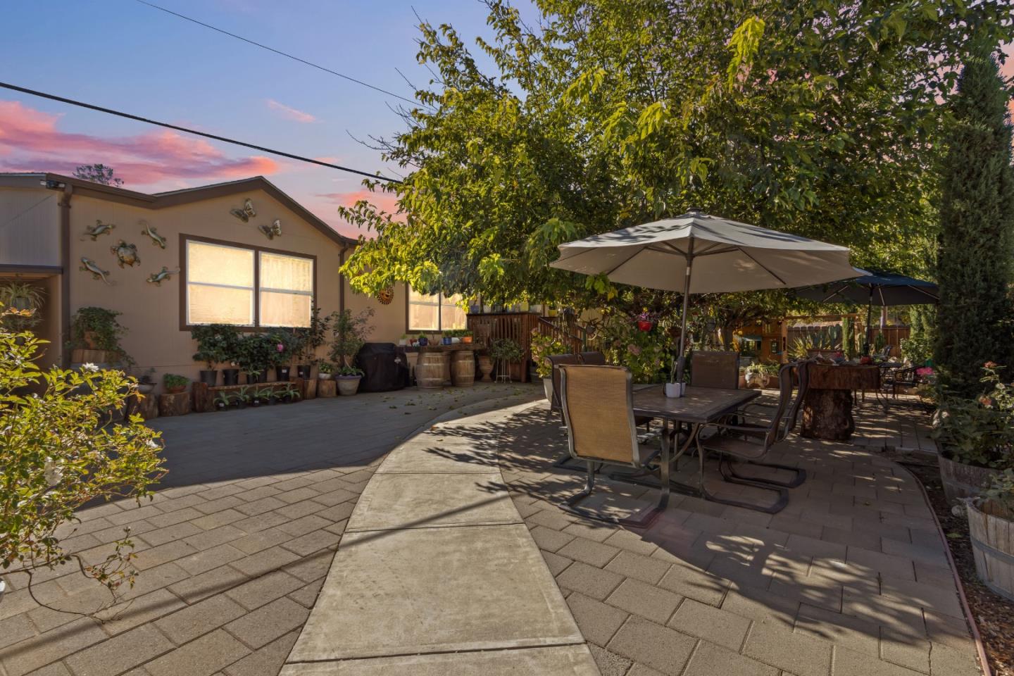 37200 Nason Road, Unit 18 Carmel Valley, CA 93924 - Photo 67 of 71 a view of a patio with a table and chairs under an umbrella