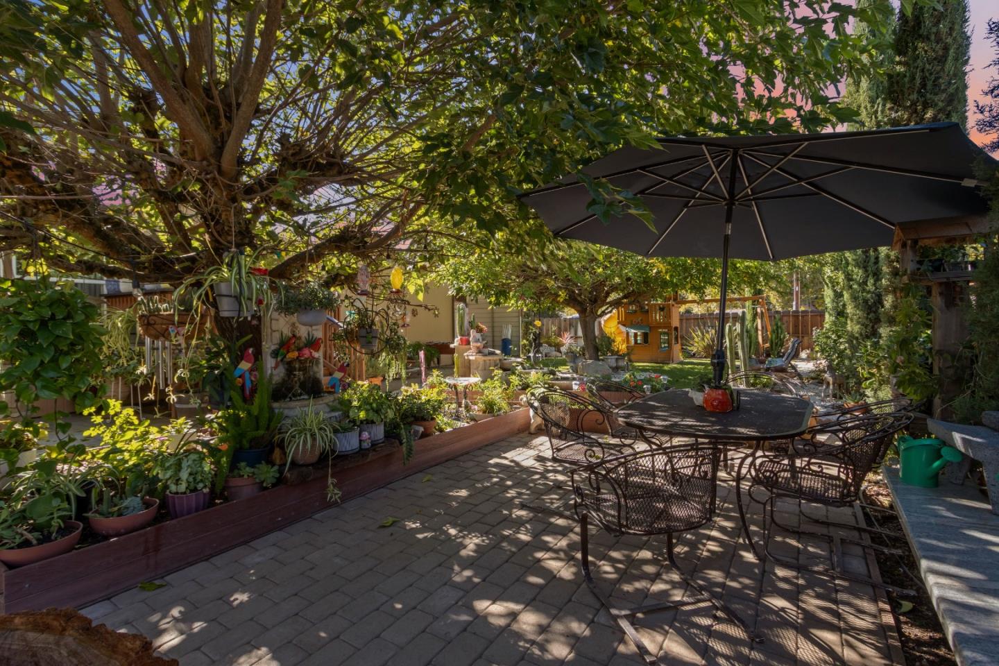37200 Nason Road, Unit 18 Carmel Valley, CA 93924 - Photo 69 of 71 a view of a patio with chairs under an umbrella