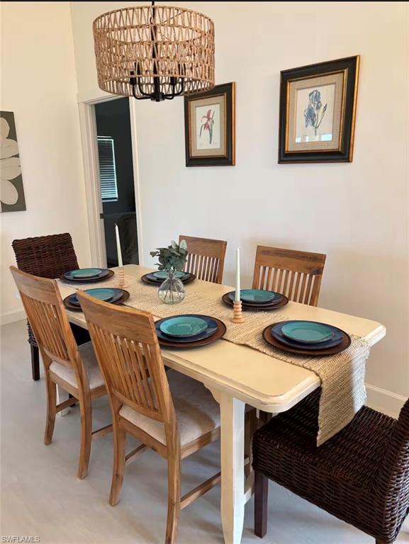 14993 Rivers Edge Court, Unit 246 Fort Myers, FL 33908 - Photo 5 of 23 a view of a dining room with furniture and wooden floor