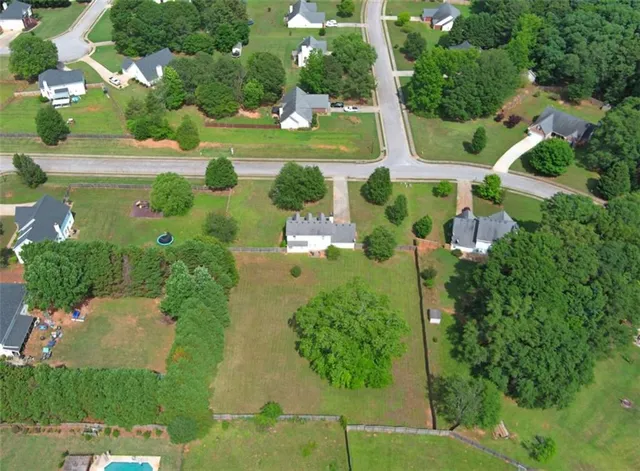 an aerial view of a house with yard swimming pool and outdoor seating