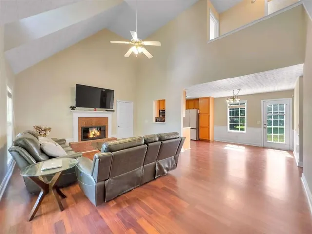 a living room with furniture a fireplace and a flat screen tv