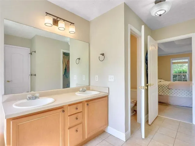 a bathroom with a sink double vanity and a mirror