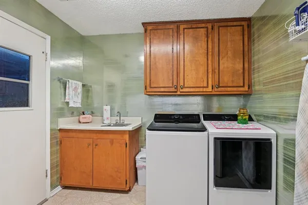 a kitchen with a sink stove and cabinets
