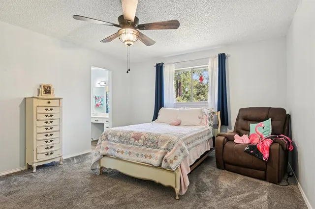 a bedroom with a bed a couch and a walk in closet