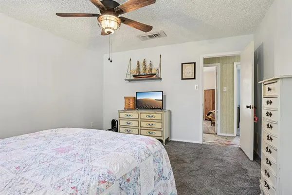 a bedroom with a bed and a tv