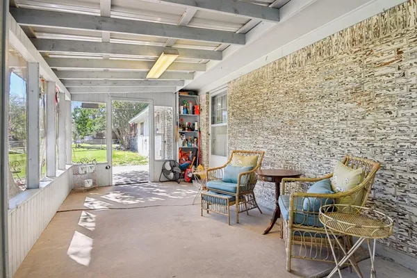 a view of a room with furniture and windows