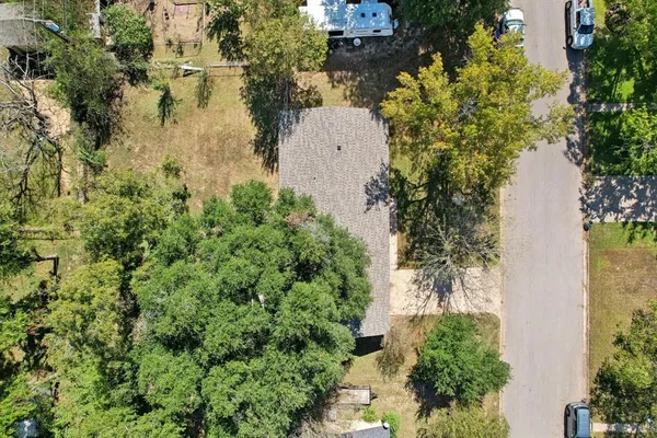 an aerial view of a house with a yard and lake view
