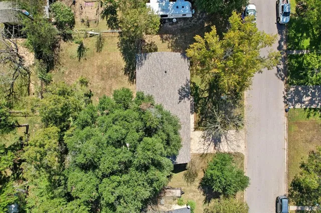 an aerial view of a house with a yard and lake view