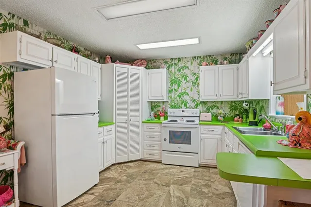 a kitchen with a refrigerator and a stove